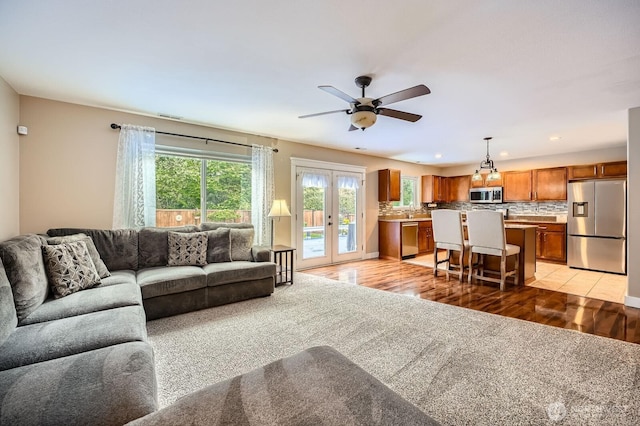 19702 99th Ct E, Bonney Lake, WA 98391 - living area with french doors, a ceiling fan, light wood-type flooring, and recessed lighting