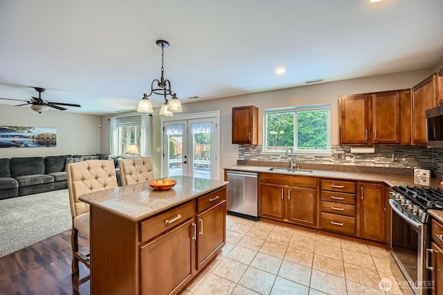 19702 99th Ct E, Bonney Lake, WA 98391 - kitchen with stainless steel appliances, a sink, brown cabinets, backsplash, and recessed lighting