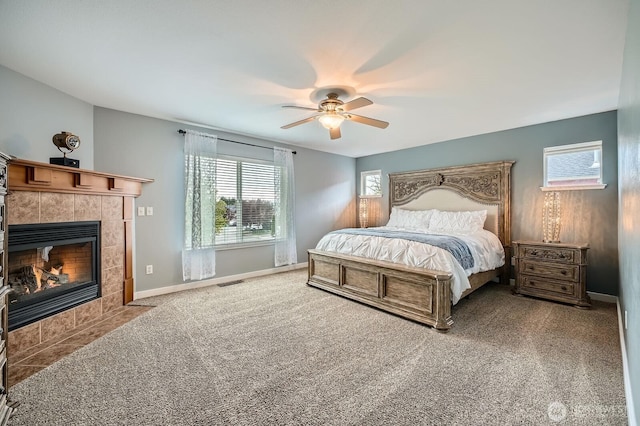 19702 99th Ct E, Bonney Lake, WA 98391 - bedroom with a fireplace, carpet, a ceiling fan, and baseboards