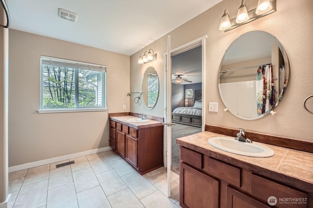 19702 99th Ct E, Bonney Lake, WA 98391 - full bathroom featuring two vanities, ceiling fan, tile patterned floors, ensuite bathroom, and baseboards