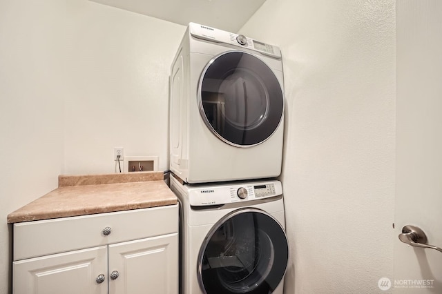 19702 99th Ct E, Bonney Lake, WA 98391 - laundry room with stacked washer and clothes dryer and cabinet space