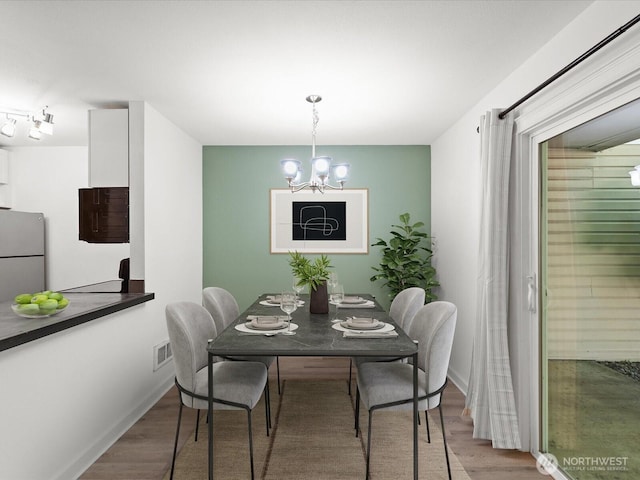 12513 NE 130th Way Unit C102, Kirkland, WA 98034 - dining room with a chandelier, wood finished floors, and baseboards