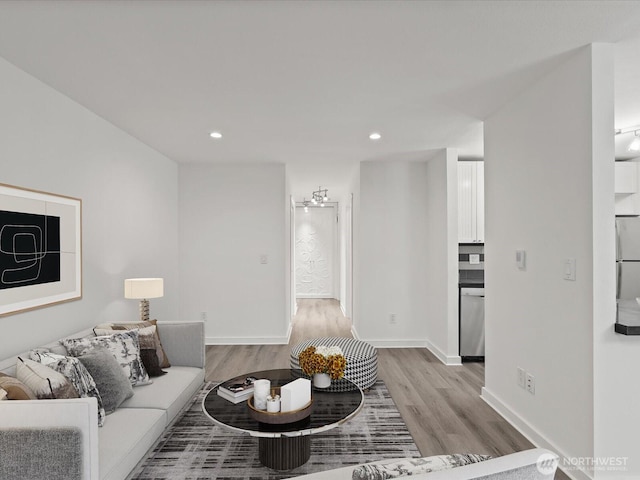 12513 NE 130th Way Unit C102, Kirkland, WA 98034 - living area with light wood finished floors, recessed lighting, and baseboards