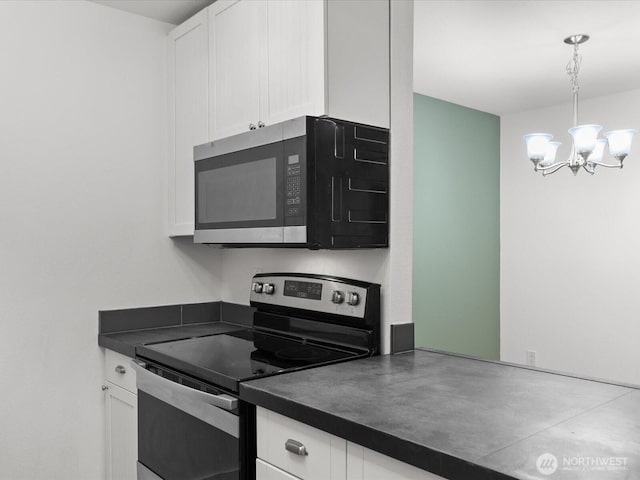12513 NE 130th Way Unit C102, Kirkland, WA 98034 - kitchen featuring stainless steel appliances, dark countertops, white cabinets, and a chandelier