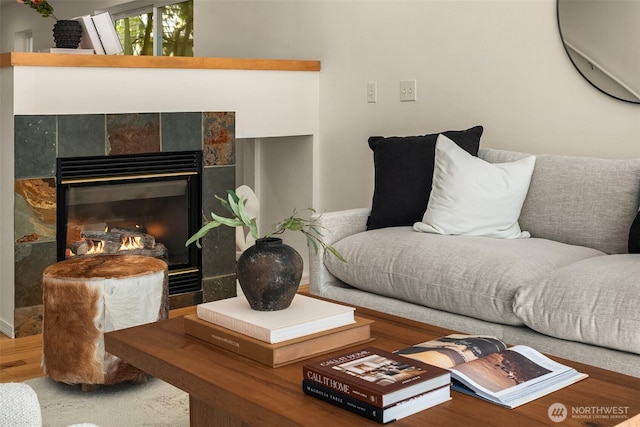 living room featuring wood finished floors and a tile fireplace