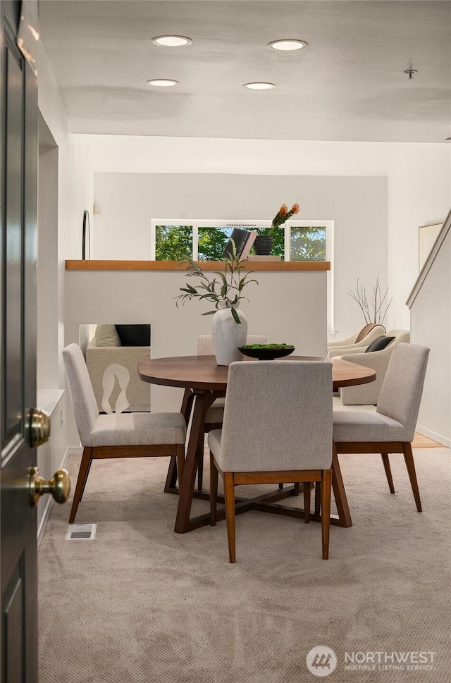 carpeted dining room with healthy amount of natural light and recessed lighting
