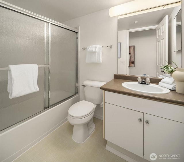 full bath featuring vanity, toilet, and combined bath / shower with glass door