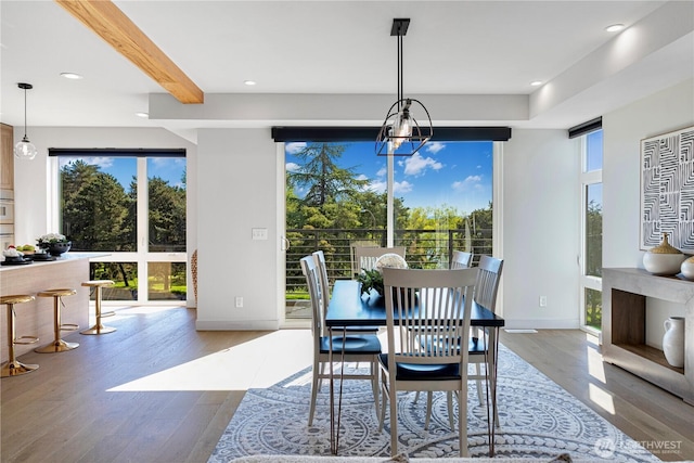 dining space featuring wood finished floors, baseboards, beamed ceiling, recessed lighting, and a chandelier