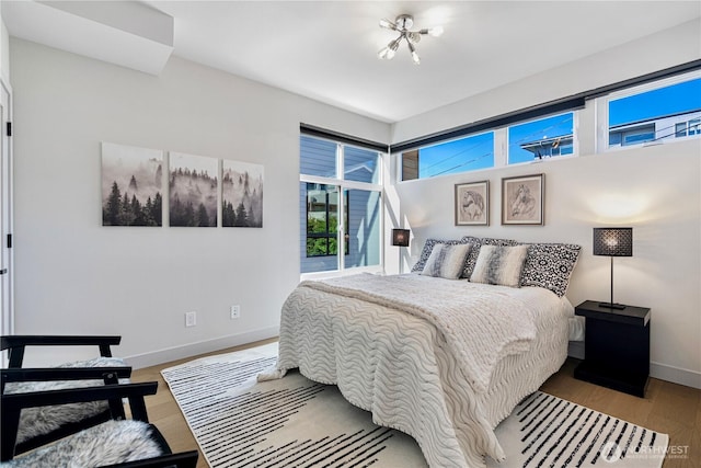 bedroom featuring baseboards and wood finished floors