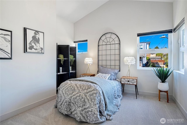bedroom with high vaulted ceiling, carpet, and baseboards