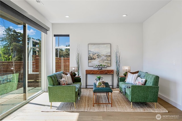 sitting room featuring wood finished floors and recessed lighting