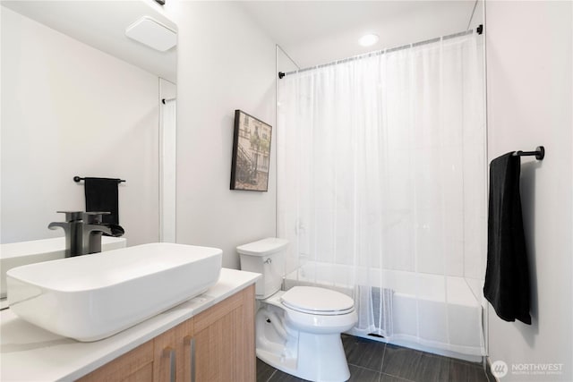 full bathroom with toilet, shower / bath combination with curtain, and vanity