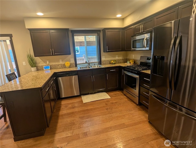 3447 Barry Pl, Mount Vernon, WA 98274 - kitchen with stainless steel appliances, a sink, a peninsula, light wood-type flooring, and recessed lighting