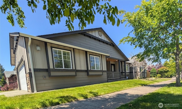 3447 Barry Pl, Mount Vernon, WA 98274 - view of home's exterior with board and batten siding, a yard, and a garage