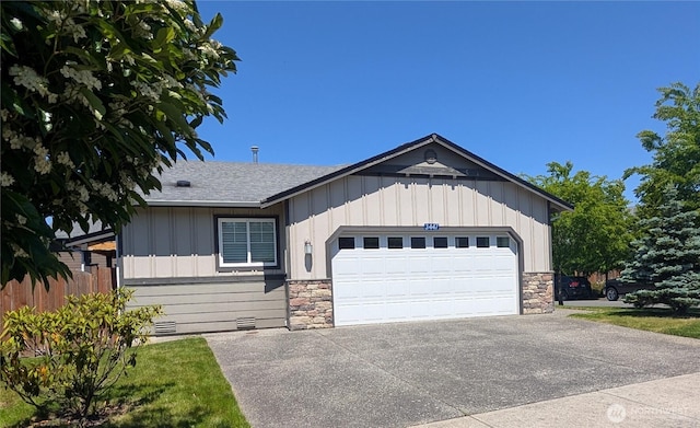 3447 Barry Pl, Mount Vernon, WA 98274 - ranch-style house with stone siding, an attached garage, driveway, and board and batten siding