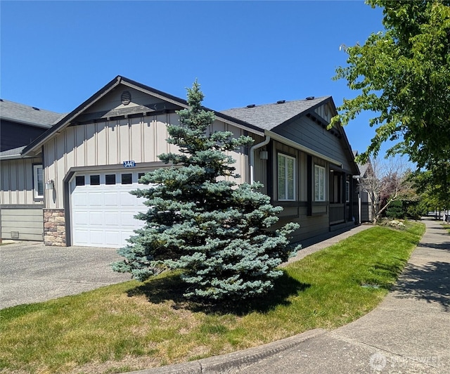 3447 Barry Pl, Mount Vernon, WA 98274 - view of front of house with board and batten siding, an attached garage, asphalt driveway, stone siding, and roof with shingles