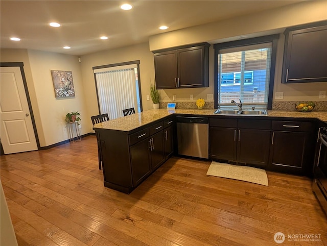 3447 Barry Pl, Mount Vernon, WA 98274 - kitchen with stainless steel dishwasher, a sink, a peninsula, hardwood / wood-style flooring, and recessed lighting