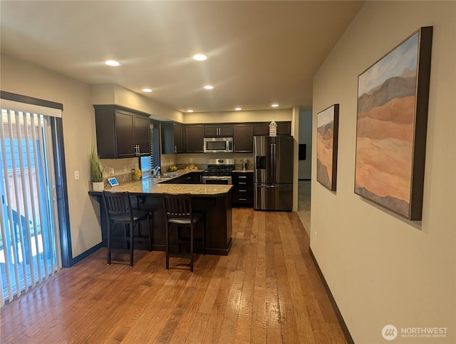 3447 Barry Pl, Mount Vernon, WA 98274 - kitchen with stainless steel appliances, light wood-style flooring, a peninsula, plenty of natural light, and recessed lighting