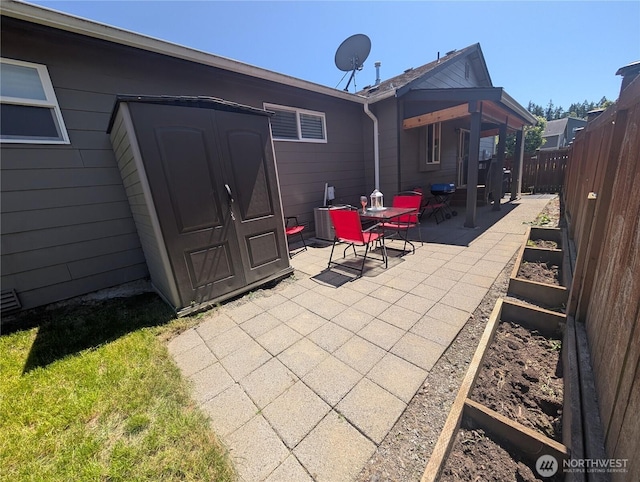 3447 Barry Pl, Mount Vernon, WA 98274 - fenced backyard featuring a patio, a vegetable garden, and outdoor dining area