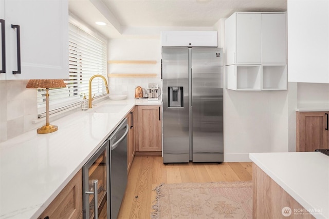 5801 Phinney Ave N Unit 103, Seattle, WA 98103 - kitchen with appliances with stainless steel finishes, wine cooler, a sink, light wood-type flooring, and open shelves
