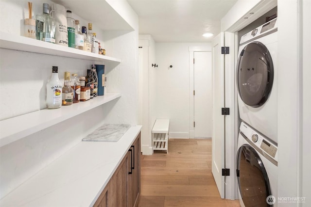 5801 Phinney Ave N Unit 103, Seattle, WA 98103 - laundry room featuring stacked washer / drying machine and light wood-style floors
