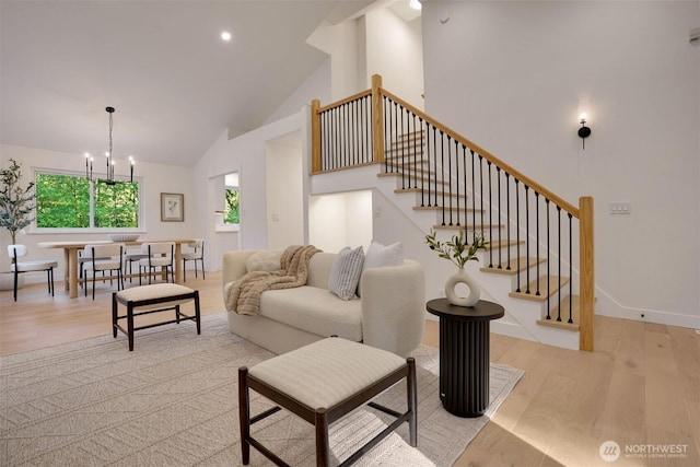 living room featuring light wood-style floors, stairway, high vaulted ceiling, a chandelier, and recessed lighting