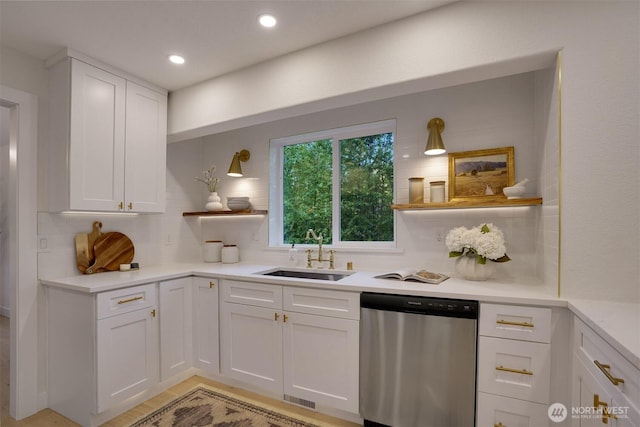 kitchen featuring dishwasher, a sink, open shelves, backsplash, and white cabinets