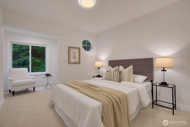 bedroom with baseboards and light colored carpet