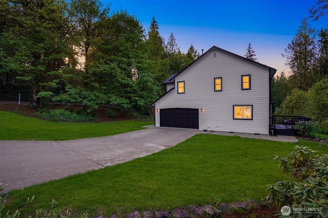 view of front of home with a garage, a front yard, concrete driveway, and a deck