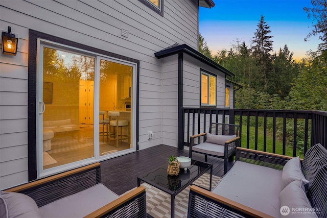 deck at dusk with an outdoor living space