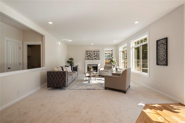 15704 124th Ave NE, Woodinville, WA 98072 - carpeted living room featuring a glass covered fireplace, baseboards, and recessed lighting