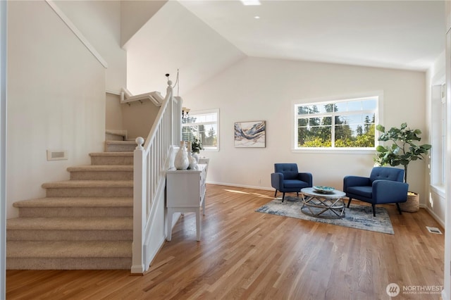 15704 124th Ave NE, Woodinville, WA 98072 - living area featuring stairs, baseboards, vaulted ceiling, and light wood-style flooring