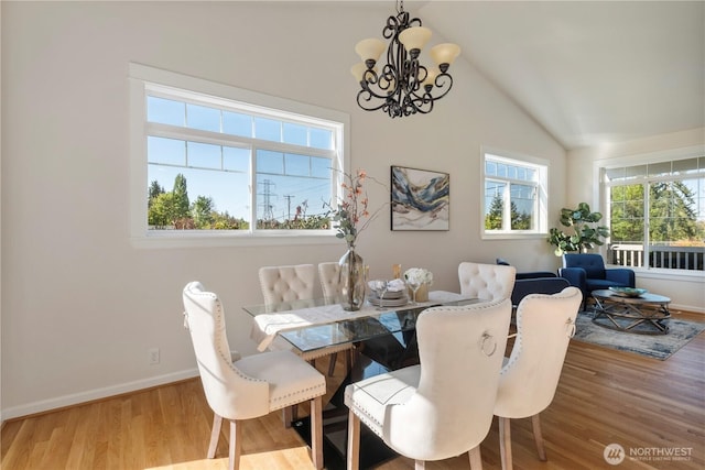 15704 124th Ave NE, Woodinville, WA 98072 - dining area with a chandelier, lofted ceiling, wood finished floors, and baseboards