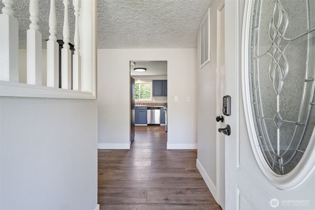 21803 NE Abernathy Rd, Yacolt, WA 98675 - foyer entrance with dark wood-style flooring, baseboards, and a textured ceiling