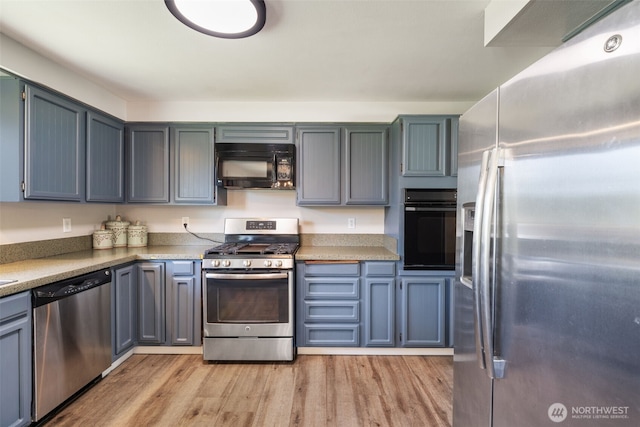 21803 NE Abernathy Rd, Yacolt, WA 98675 - kitchen featuring black appliances, light wood finished floors, and light countertops