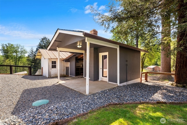 21803 NE Abernathy Rd, Yacolt, WA 98675 - back of property featuring a chimney, fence, and a patio area