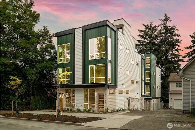 2108 15th Ave S Unit C, Seattle, WA 98144 - view of front of home with concrete driveway, board and batten siding, and an attached garage