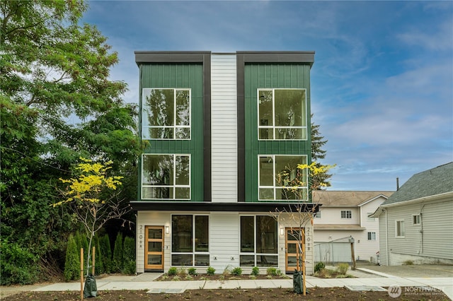 2108 15th Ave S Unit C, Seattle, WA 98144 - rear view of house featuring an attached garage and concrete driveway