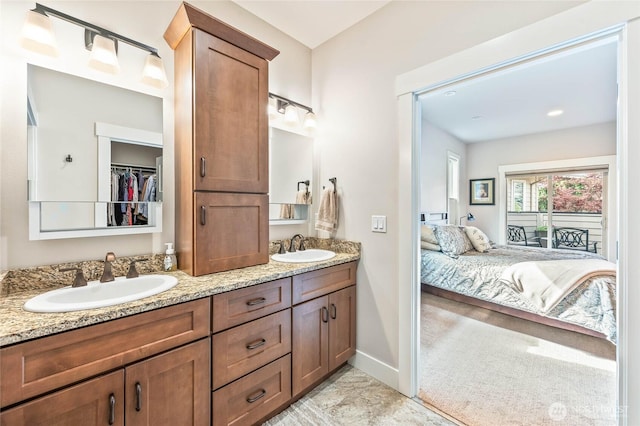 411 19th St NE Unit 9, East Wenatchee, WA 98802 - ensuite bathroom with double vanity, baseboards, marble finish floors, and a spacious closet
