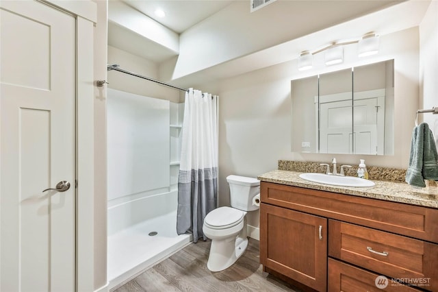 411 19th St NE Unit 9, East Wenatchee, WA 98802 - full bath featuring wood finished floors, a shower stall, toilet, vanity, and baseboards