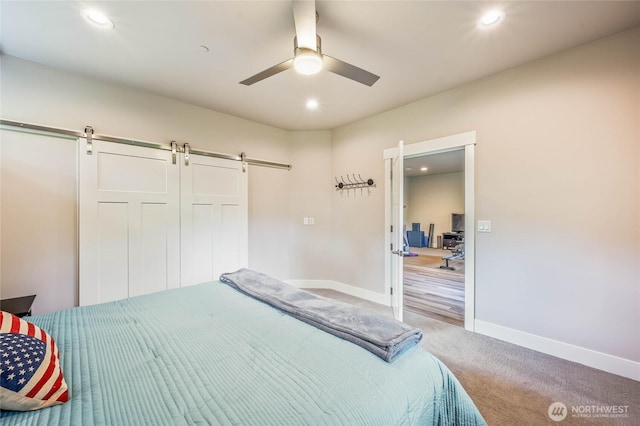 411 19th St NE Unit 9, East Wenatchee, WA 98802 - bedroom featuring a barn door, carpet floors, recessed lighting, baseboards, and a ceiling fan