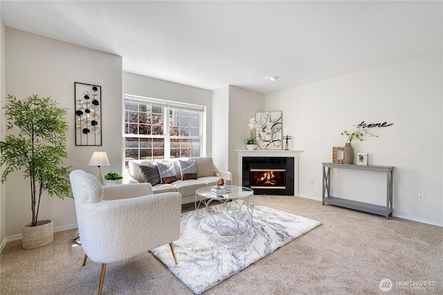 carpeted living room featuring a fireplace and baseboards