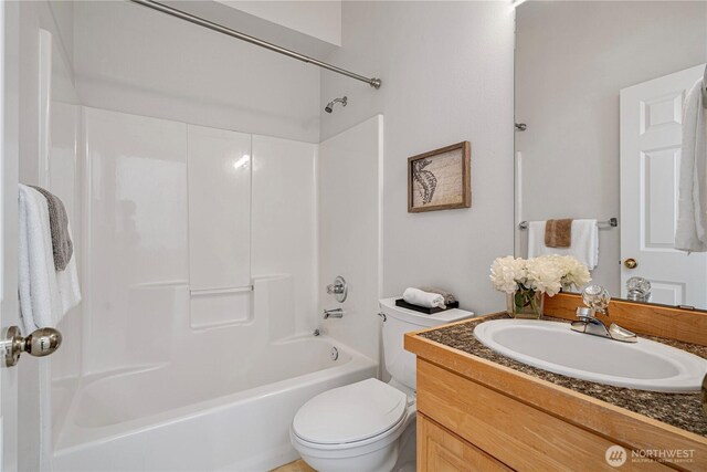 bathroom with vanity, toilet, and shower / washtub combination