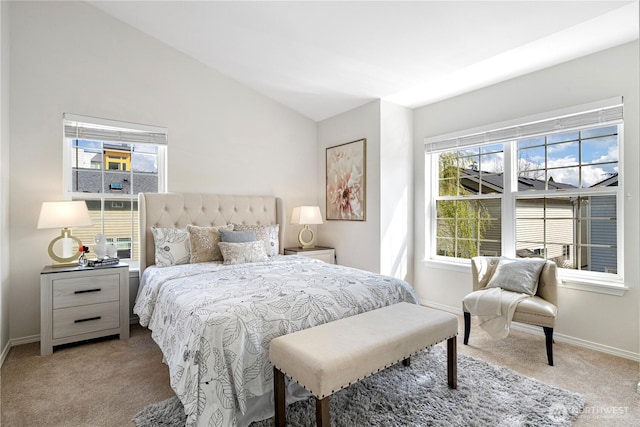 carpeted bedroom with baseboards and lofted ceiling