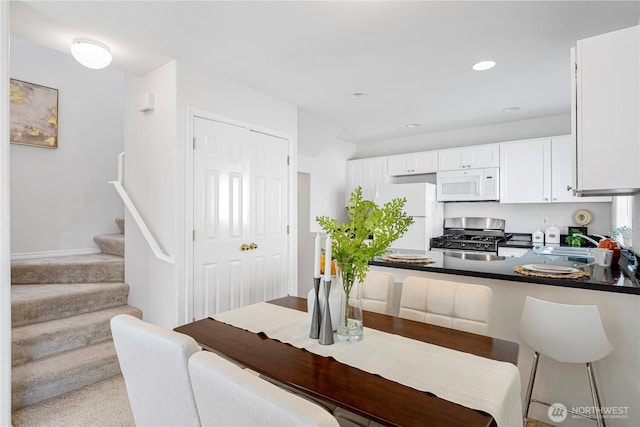 dining area featuring stairway and recessed lighting