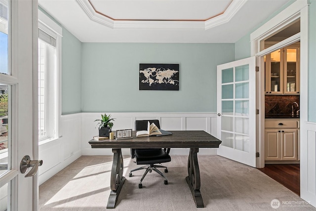 home office featuring healthy amount of natural light, french doors, a tray ceiling, carpet, and ornamental molding