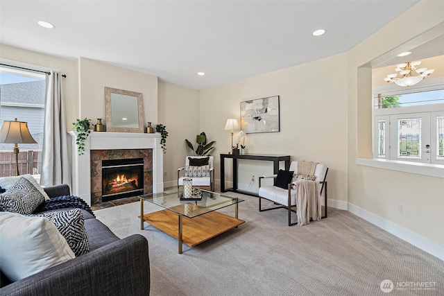 living room featuring a chandelier, carpet flooring, a tile fireplace, recessed lighting, and baseboards