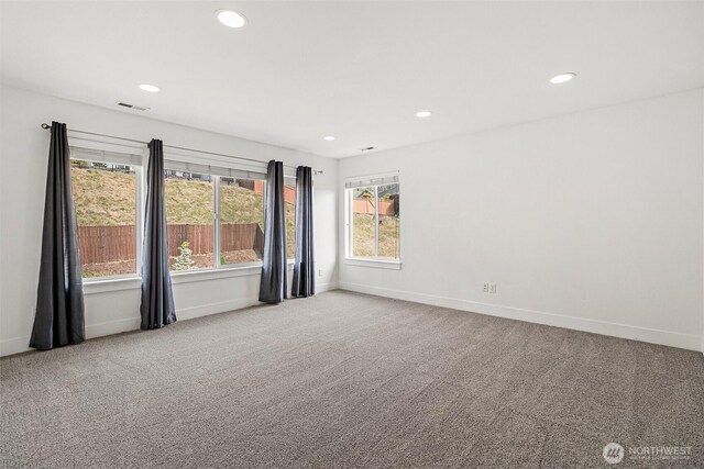 carpeted empty room featuring baseboards and recessed lighting