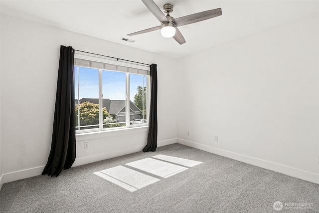 empty room featuring ceiling fan, baseboards, and carpet flooring
