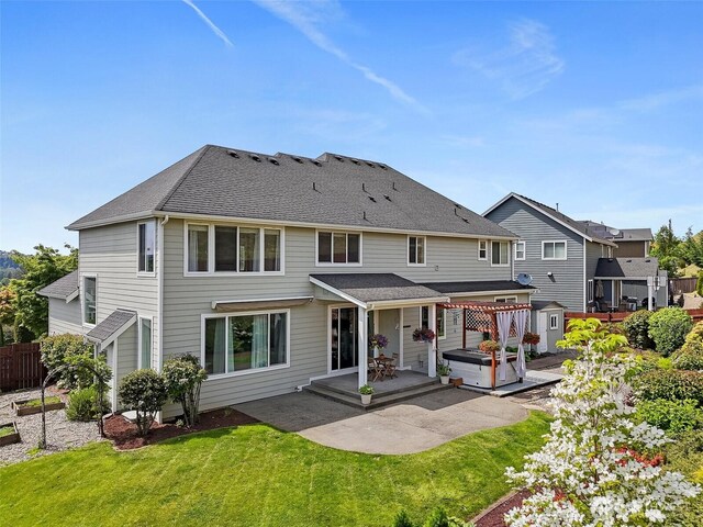 back of house featuring a patio, a storage shed, and an outbuilding